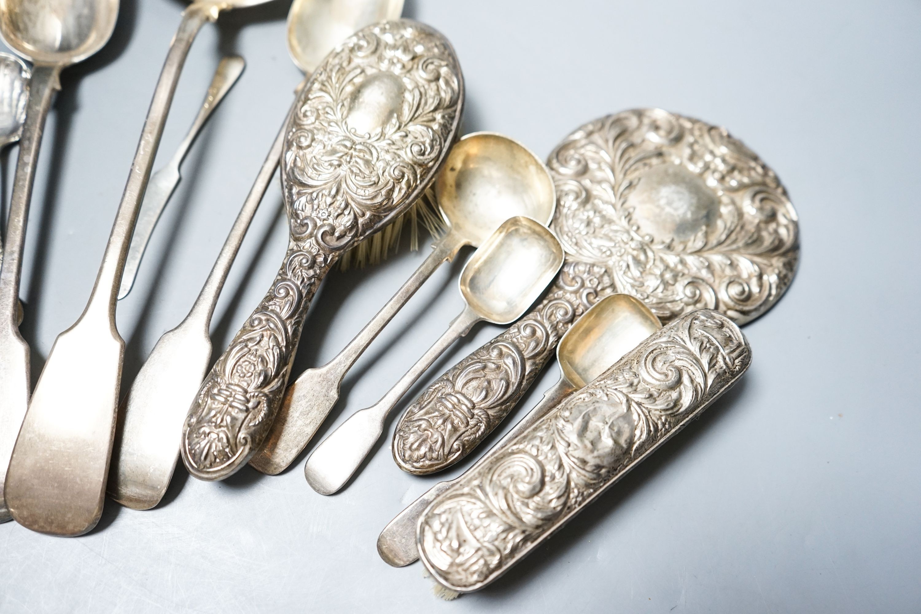 A group of silver flatware including a Victorian soup ladle and two basting spoons and three dressing table accessories, weighable silver 24oz